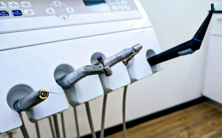 Close-up of dental instruments in a professional dental clinic setting.
