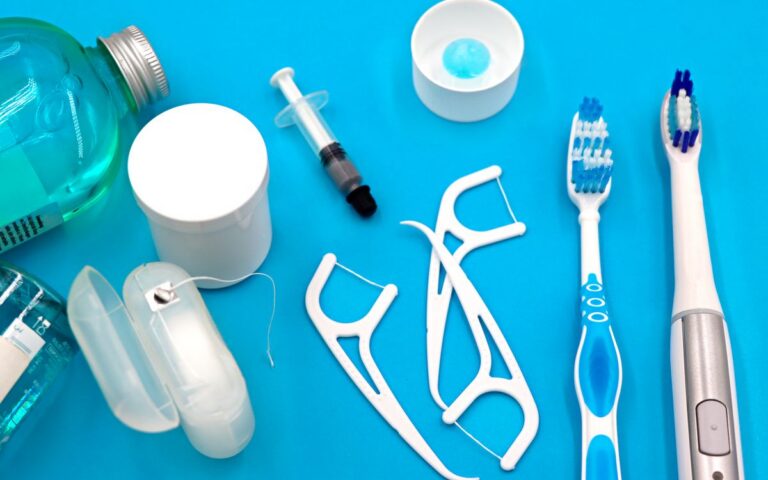 A variety of dental hygiene tools arranged neatly on a vibrant blue surface, showcasing oral care essentials.