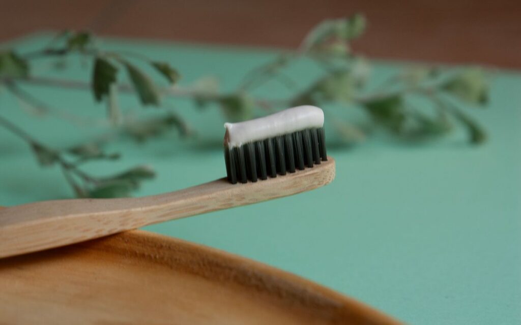 Sustainable bamboo toothbrush with herbal toothpaste. Ideal for eco-friendly living.