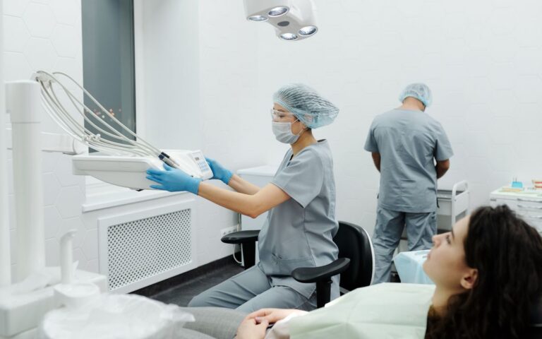Dental professionals in action within a modern clinic, treating a patient.
