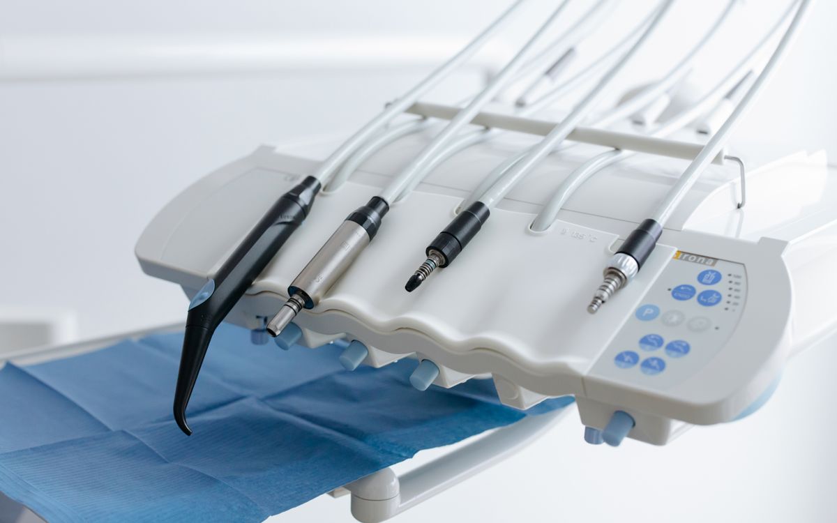 Close-up of dental equipment with handpieces, showcasing modern dental care tools in a clinic.