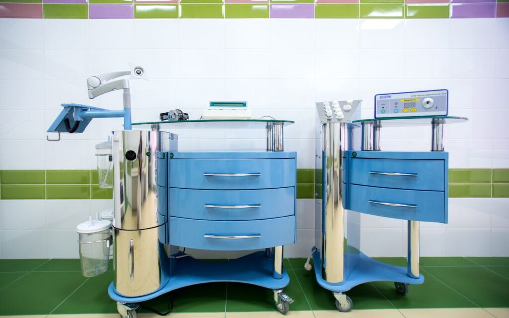 Two modern dental equipment carts in a sterile clinic environment, emphasizing hygiene.