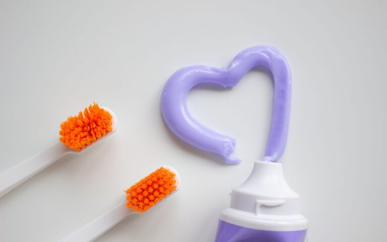 Bright image of toothbrushes and heart-shaped toothpaste promoting dental hygiene.